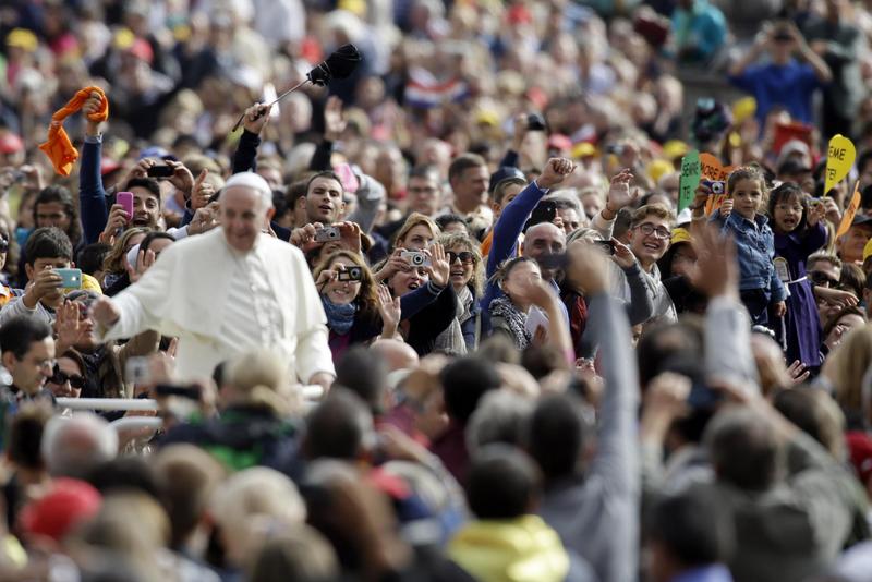 Faithful cheer Pope Francis during the weekly general audience in St. Peter's Square, at the Vatican, Wednesday, Oct. 9, 2013. (AP Photo/Gregorio Borgia)